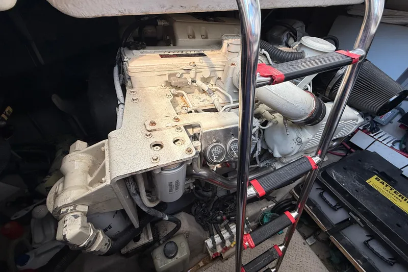 Slide: The Image of Engine compartment of a 2005 Sea Ray 48 Sundancer with visible components and ladder. - 105