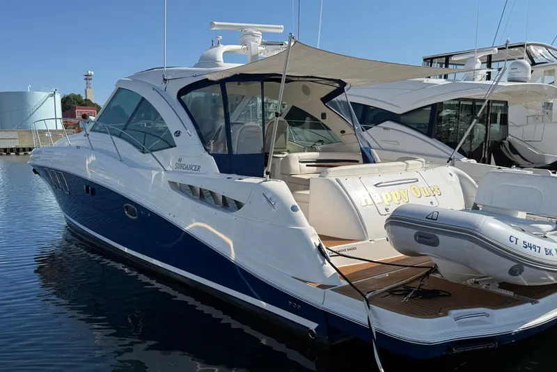 The Image of 2005 Sea Ray 48 Sundancer yacht docked with inflatable boat attached. - 0