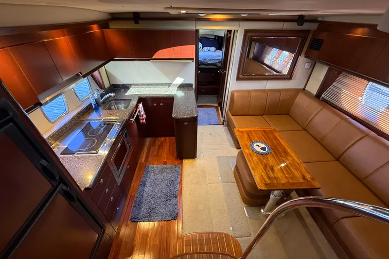 Slide: The Image of Luxurious interior of 2005 Sea Ray 48 Sundancer yacht with kitchen and seating area. - 67