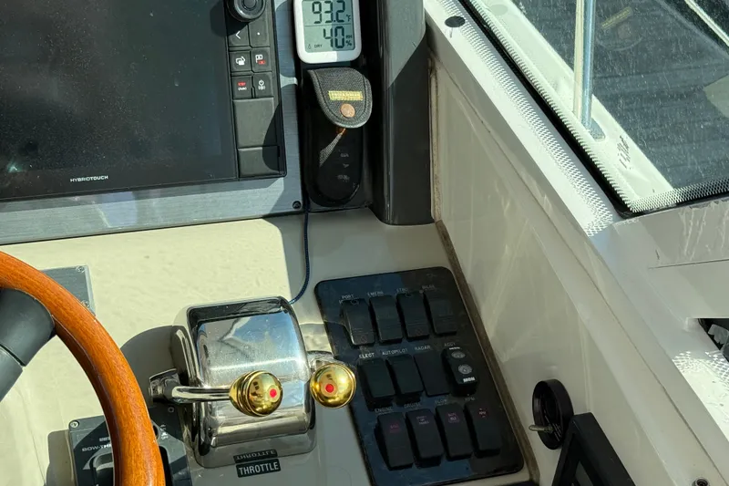 Slide: The Image of Control panel of a 2005 Sea Ray 48 Sundancer yacht with throttle and navigation instruments. - 42