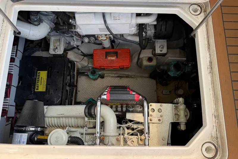 Slide: The Image of Engine compartment of a 2005 Sea Ray 48 Sundancer boat, showing mechanical components. - 117