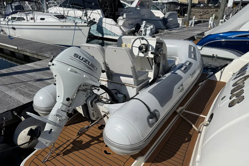 Slide: The Image of 2005 Sea Ray 48 Sundancer with Suzuki outboard motor at marina dock. - 4