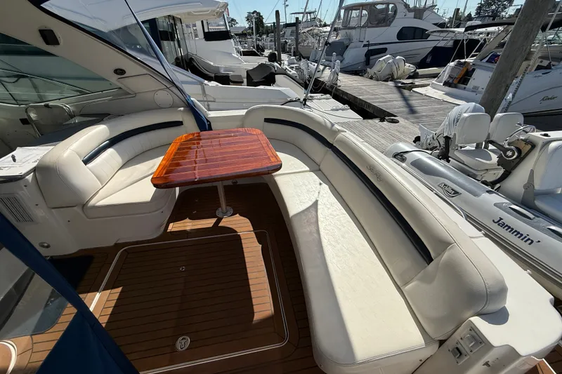 Slide: The Image of Luxurious 2005 Sea Ray 48 Sundancer yacht interior with elegant seating and wooden table. - 12