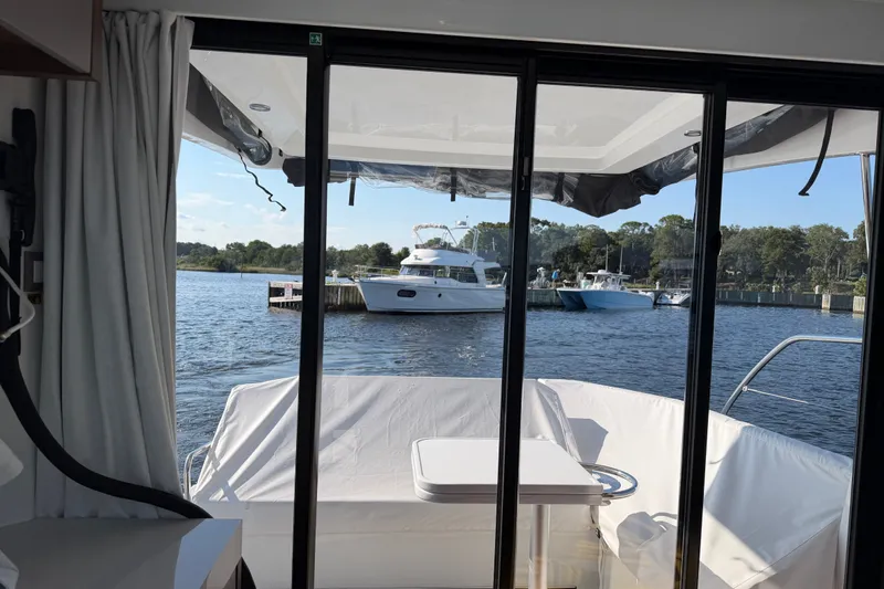 Slide: The Image of View from inside a 2026 Beneteau Antares 11, overlooking a serene marina. - 39