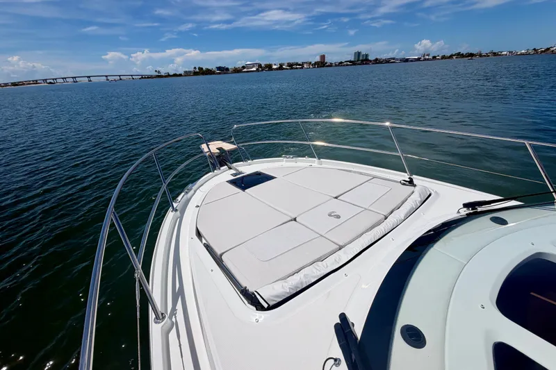 Slide: The Image of 2026 Beneteau Antares 11 yacht on calm waters with city skyline in background. - 27