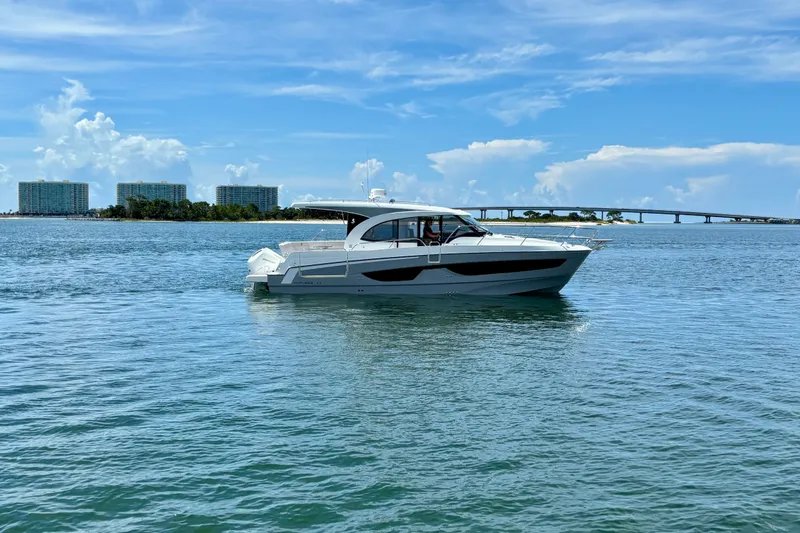 The Image of 2026 Beneteau Antares 11 yacht cruising on a sunny day with scenic background. - 0