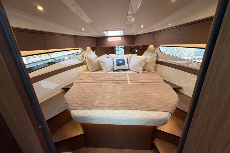 Slide: The Image of Luxurious cabin interior of 2026 Beneteau Antares 11 with cozy bedding and elegant wood finishes. - 31