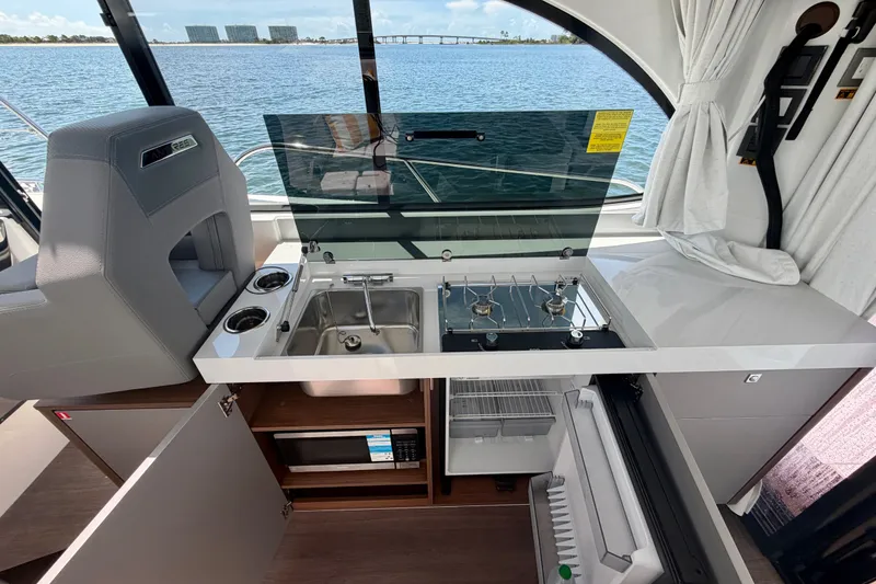Slide: The Image of Modern kitchen area on 2026 Beneteau Antares 11 yacht with sink, stove, and fridge. - 15