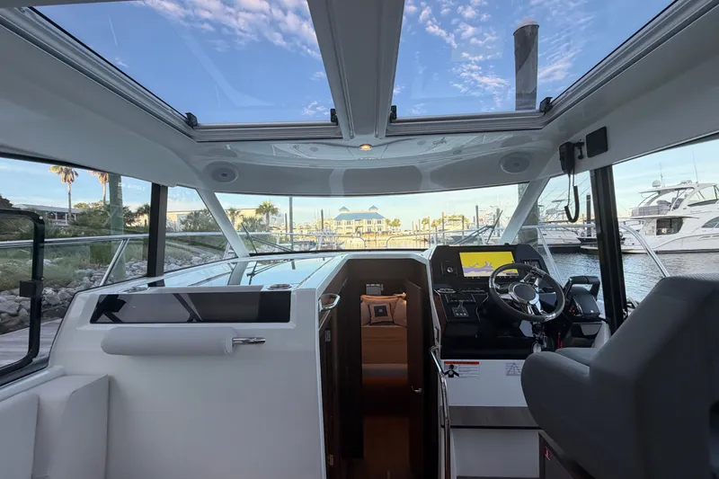 Slide: The Image of Interior view of 2026 Beneteau Antares 11 yacht, showcasing helm and panoramic windows. - 29