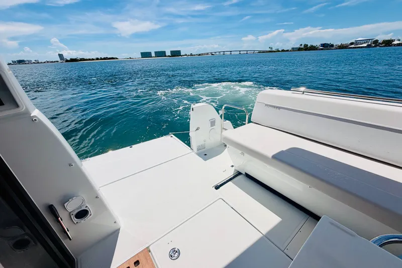 Slide: The Image of 2026 Beneteau Antares 11 boat deck overlooking serene blue waters and distant skyline. - 11