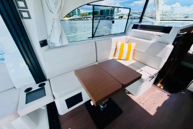 Slide: The Image of Interior of 2026 Beneteau Antares 11 yacht with cozy seating and table. - 19