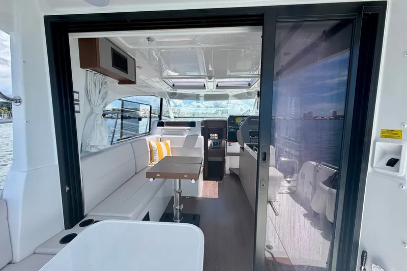 Slide: The Image of Interior view of 2026 Beneteau Antares 11 yacht, featuring modern seating and table. - 23