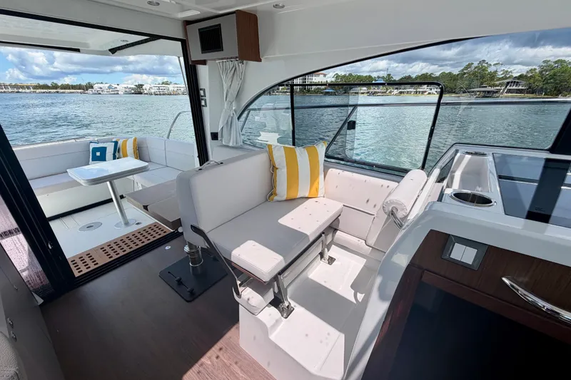Slide: The Image of Interior of 2026 Beneteau Antares 11 yacht with seating and scenic water view. - 20