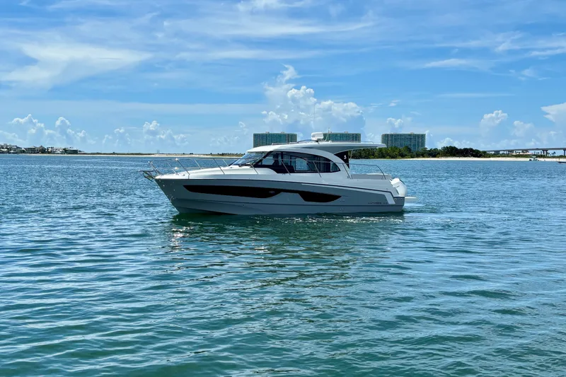 Slide: The Image of 2026 Beneteau Antares 11 yacht cruising on a sunny day, calm waters. - 4