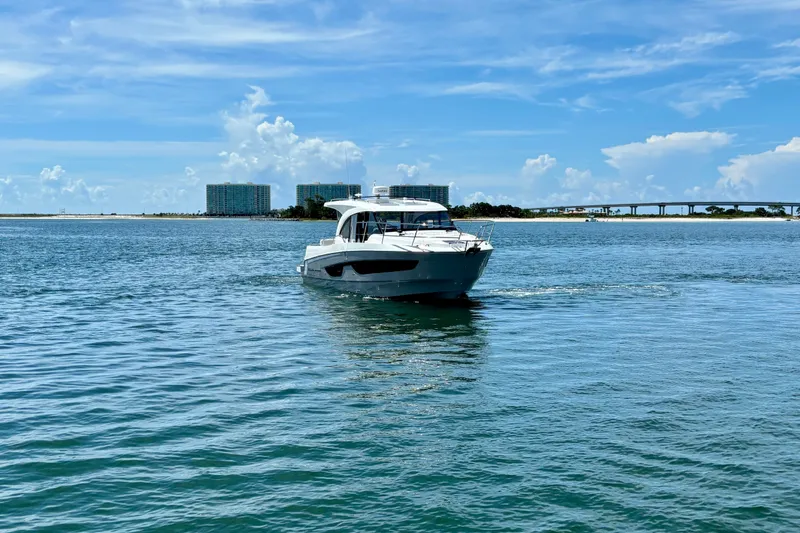 Slide: The Image of 2026 Beneteau Antares 11 cruising on a sunny day with scenic coastal backdrop. - 1