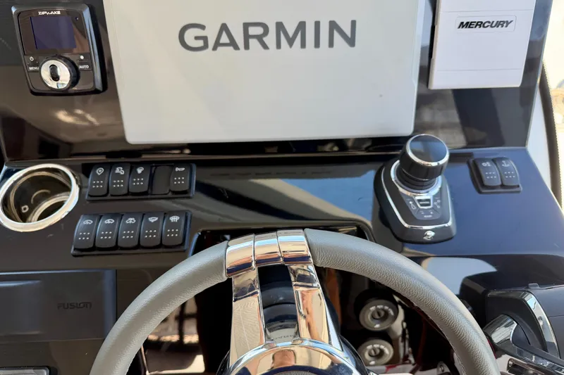 Slide: The Image of The image shows the helm of a Beneteau Antares 11 boat with Garmin and Mercury equipment. - 18