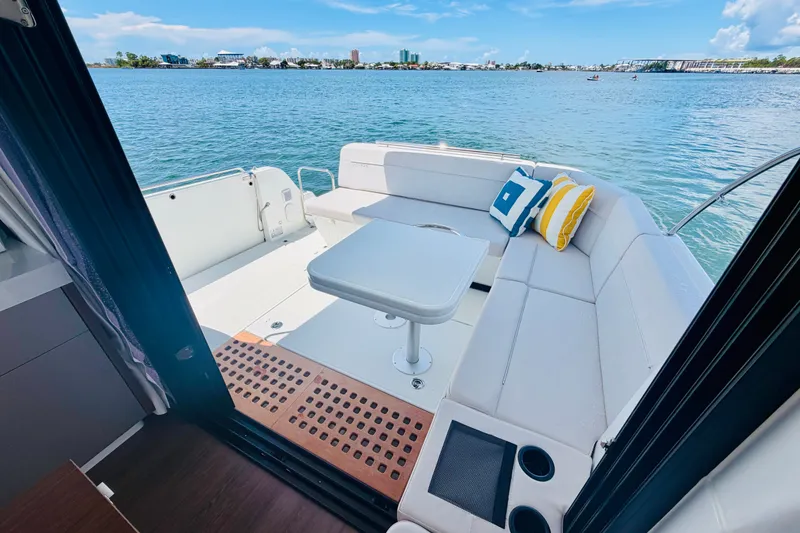 Slide: The Image of 2026 Beneteau Antares 11 boat interior with seating area and scenic water view. - 10