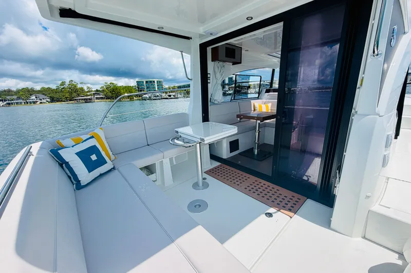 Slide: The Image of 2026 Beneteau Antares 11 yacht interior with seating, table, and scenic waterfront view. - 22