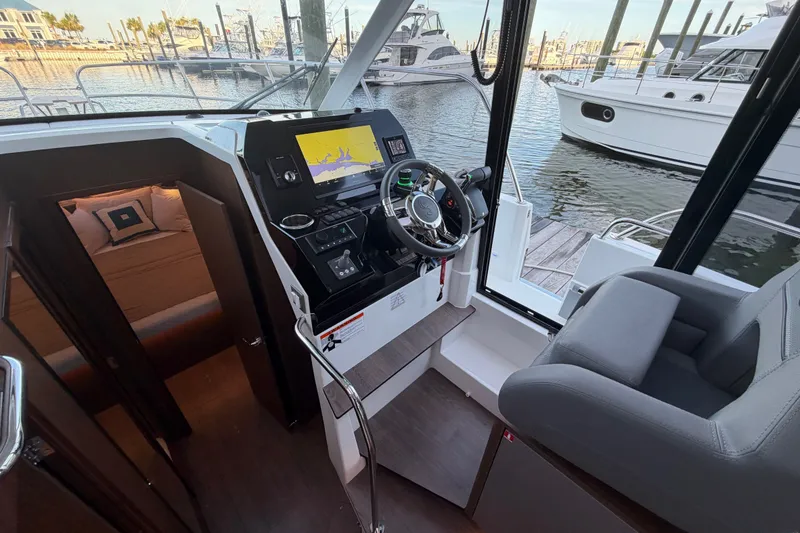 Slide: The Image of Interior view of 2026 Beneteau Antares 11 boat cockpit with steering wheel and navigation system. - 28