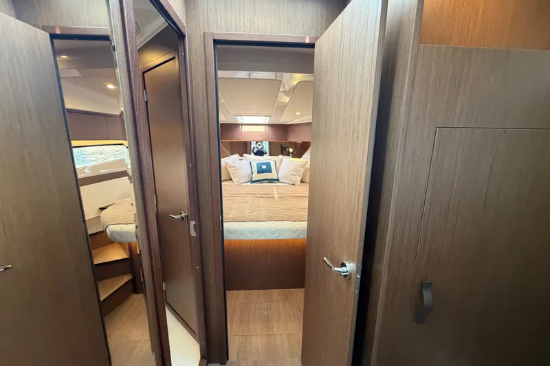 Slide: The Image of Interior view of 2026 Beneteau Antares 11 cabin with cozy bedding and wooden finishes. - 30