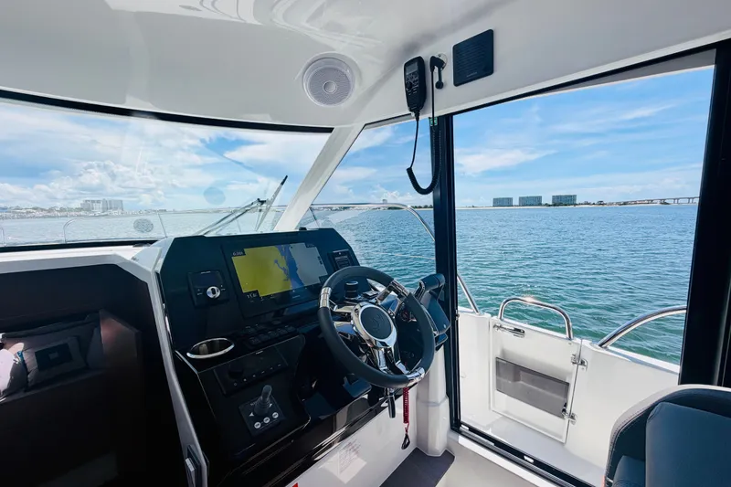 Slide: The Image of Interior view of 2026 Beneteau Antares 11 boat cockpit with ocean backdrop. - 17