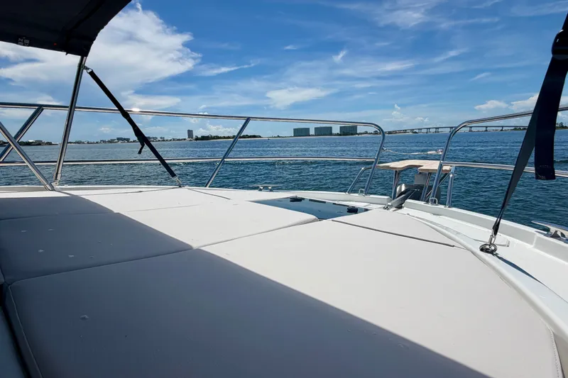 Slide: The Image of 2026 Beneteau Antares 11 yacht deck with ocean view and city skyline. - 25