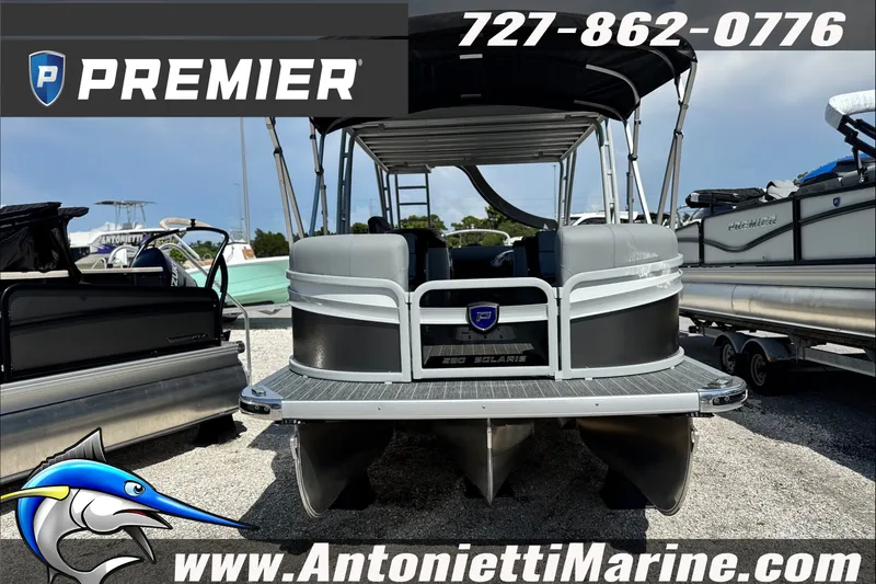 Slide: The Image of Premier 250 Solaris Upper Deck CL 2027 pontoon boat at Antonietti Marine dealership. - 2
