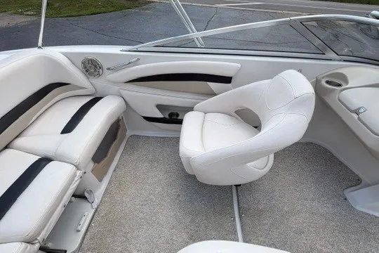 Slide: The Image of Interior of a 2011 Glastron GT 205 boat with white seating and modern design. - 26