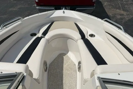 Slide: The Image of 2011 Glastron GT 205 boat interior with white and black seating, cup holders, and carpeted floor. - 19