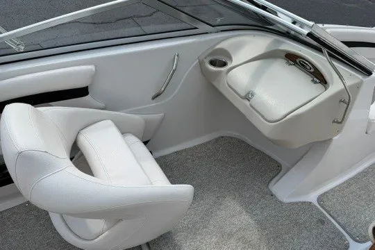 Slide: The Image of 2011 Glastron GT 205 boat interior with white seating and dashboard. - 25