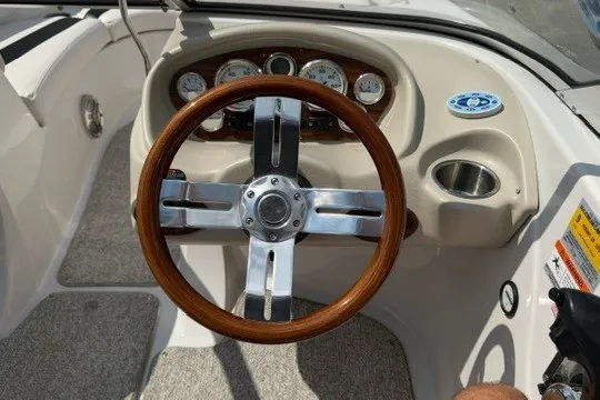 Slide: The Image of Steering wheel and dashboard of a 2011 Glastron GT 205 boat. - 15