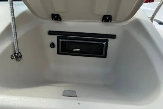 Slide: The Image of 2011 Glastron GT 205 boat storage compartment with USB port and secure latch. - 23