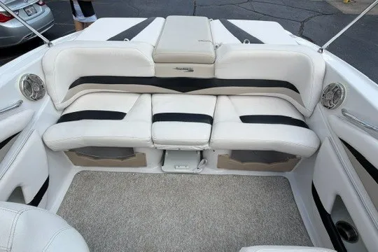 Slide: The Image of 2011 Glastron GT 205 boat interior with white and black seating, carpeted floor. - 24
