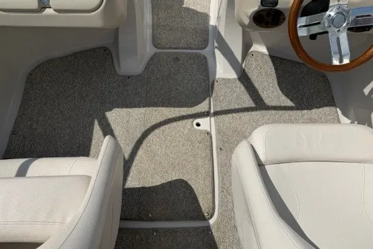 Slide: The Image of Interior of 2011 Glastron GT 205 boat with beige seats and carpeted floor. - 17