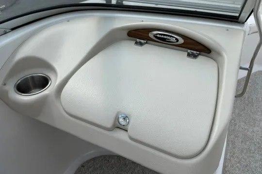 Slide: The Image of 2011 Glastron GT 205 boat interior with glove compartment and cup holder. - 21