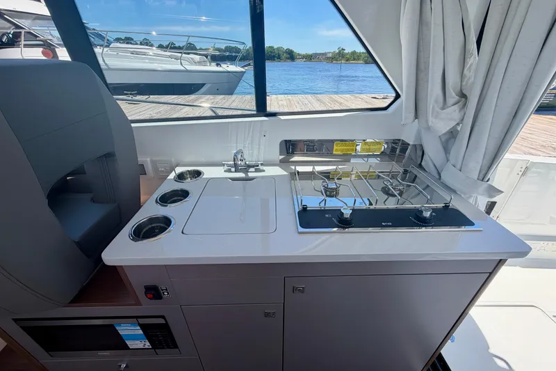 Slide: The Image of Interior view of 2026 Beneteau Antares 9 yacht kitchen with stove and sink. - 26
