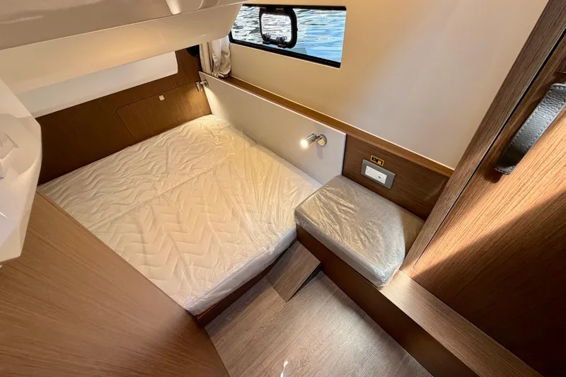 Slide: The Image of Cozy cabin interior of 2026 Beneteau Antares 9 with bed and window view. - 21