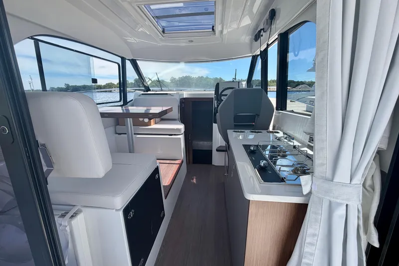 Slide: The Image of Interior of 2026 Beneteau Antares 9 boat, featuring modern seating and kitchen area. - 25
