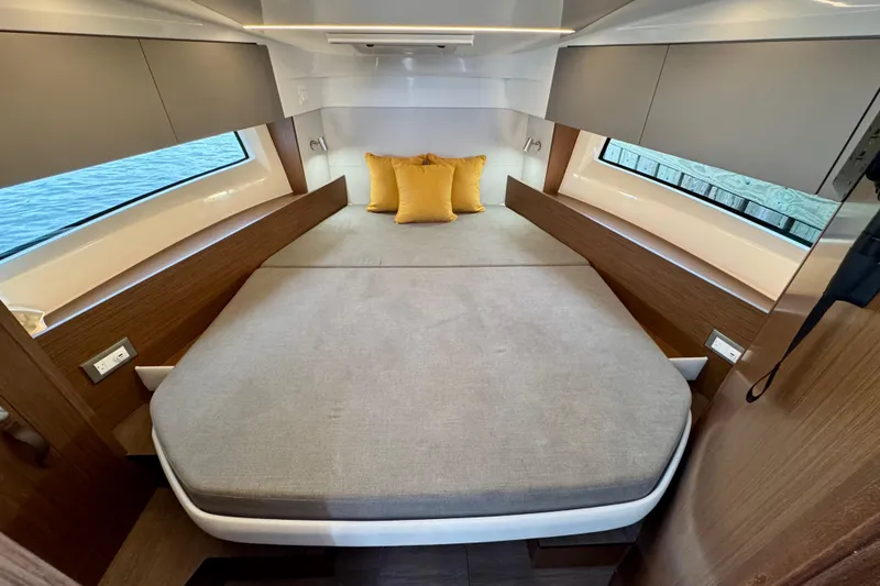 Slide: The Image of Luxurious cabin interior of 2026 Beneteau Antares 9 with cozy bed and yellow pillows. - 19