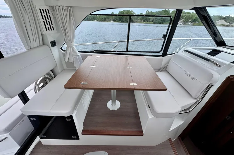 Slide: The Image of Interior of 2026 Beneteau Antares 9, featuring a sleek dining area with wood table. - 14
