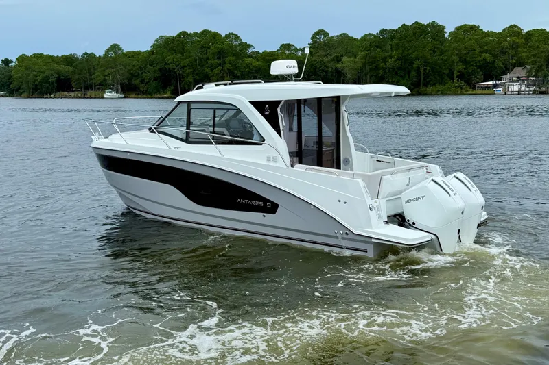 Slide: The Image of 2026 Beneteau Antares 9 motorboat cruising on a serene lake. - 2