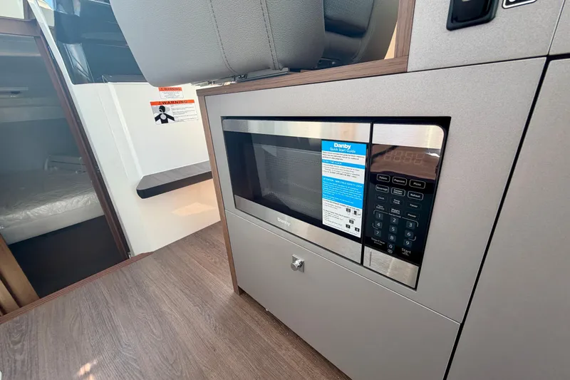 Slide: The Image of Modern kitchen area in 2026 Beneteau Antares 9 with built-in microwave. - 28