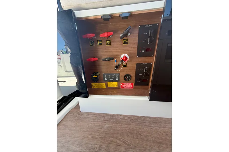 Slide: The Image of Electrical panel of 2026 Beneteau Antares 9 boat, featuring switches and controls. - 16
