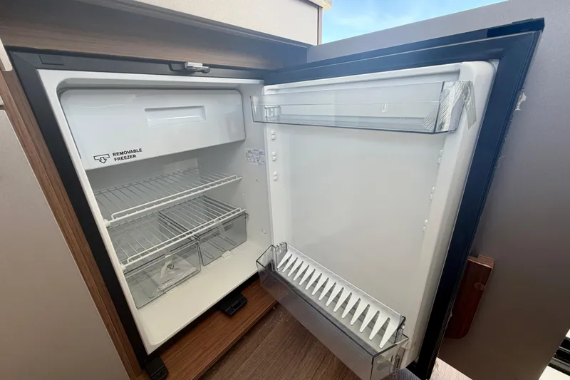 Slide: The Image of Open refrigerator with removable freezer in 2026 Beneteau Antares 9 boat interior. - 27