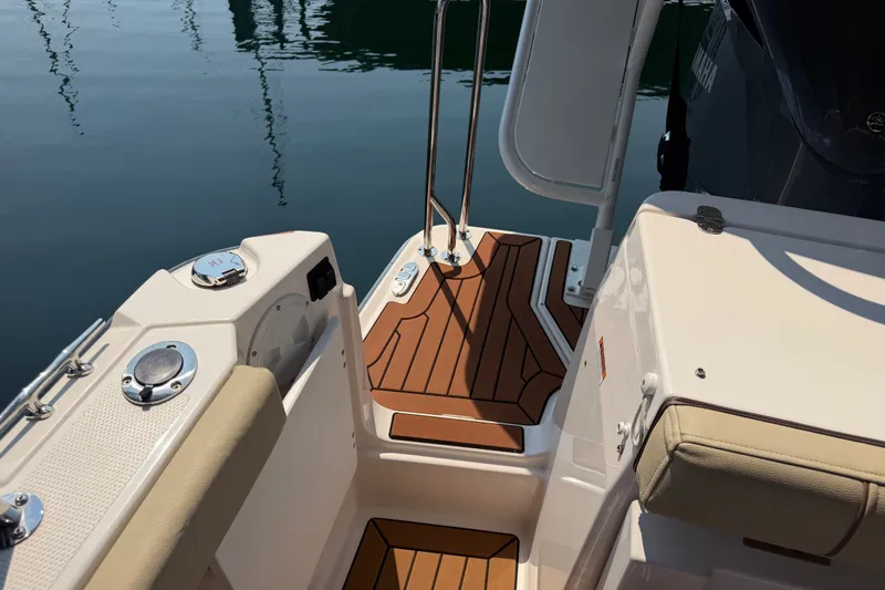 Slide: The Image of 2024 Ranger Tugs R-27 boat deck with teak flooring and stainless steel fittings. - 14
