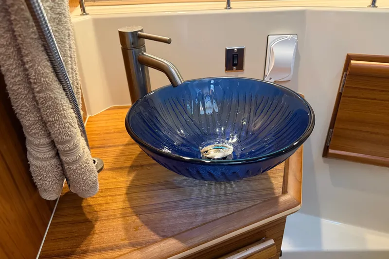 Slide: The Image of Elegant blue glass sink in 2024 Ranger Tugs R-27 boat bathroom. - 46