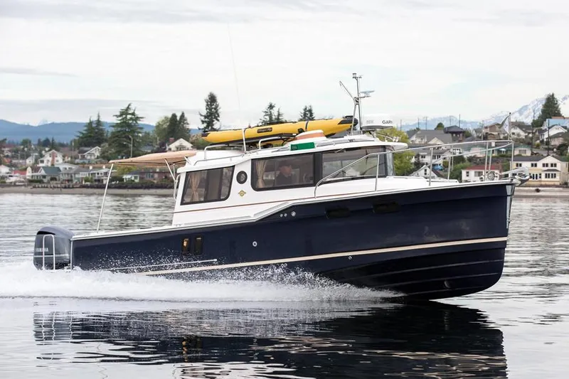 Slide: The Image of Manufacturer Provided Image: 2024 Ranger Tugs R-27 cruising on a calm lake near a residential area. - 59