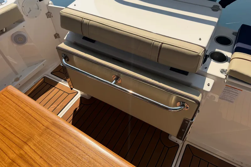 Slide: The Image of 2024 Ranger Tugs R-27 interior with cushioned seating and teak flooring. - 6