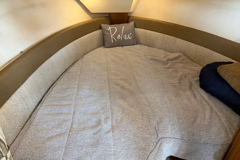 Slide: The Image of Cozy cabin bed in 2024 Ranger Tugs R-27 boat with "Relax" pillow. - 41