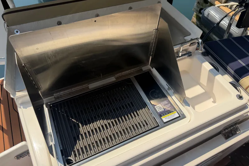 Slide: The Image of Outdoor grill and sink on 2024 Ranger Tugs R-27 boat deck. - 9